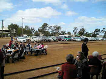 Cars lined up near the railway reserve