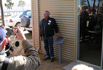 Jim Ellison unveils the plaque at the Jim Ellison Machinery Shed